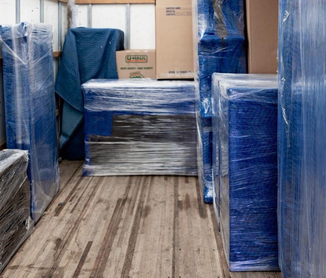 alt="A moving truck well packed with protected furniture"